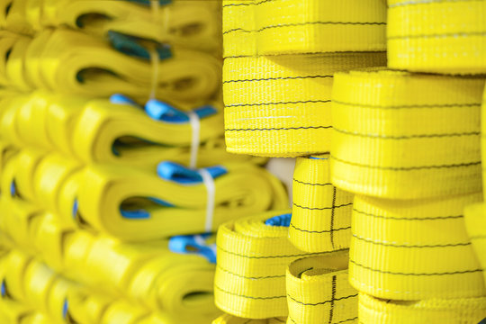 Yellow Nylon Soft Lifting Slings Stacked In Piles.