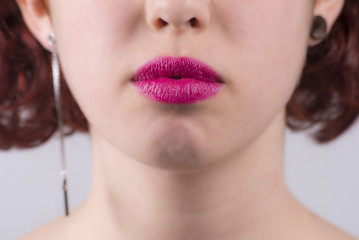 Close up of red glossy female lips closed
