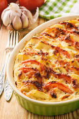Vegetarian meal - potato casserole with tomatoes, garlic and cheese.