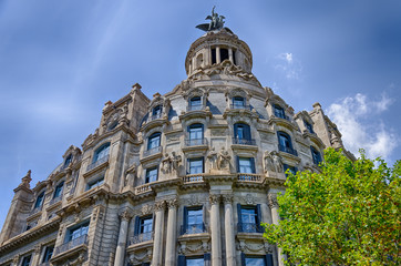 Fototapeta na wymiar Interesting facade with statues on blue sky background in Barcelona, Spain
