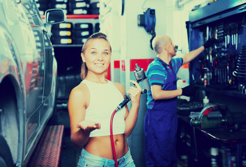 Fototapeta na wymiar Adult woman working in car workshop