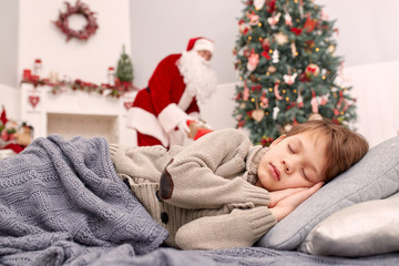 Fototapeta na wymiar Santa Claus leaves a presents while child sleeps