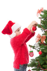 Obraz na płótnie Canvas Little girl hanging Christmas decoration on the tree
