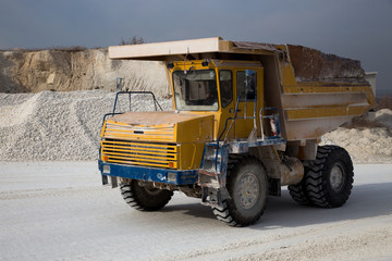 Moving dump truck full of chalk in quarry 