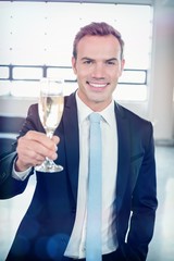Portrait of businessman holding champagne flute