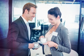 Businessman and businesswoman having tea during breaktime