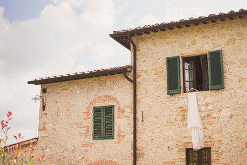 Bridal fashion. Lace wedding dress hanging outside the vintage italian villa.