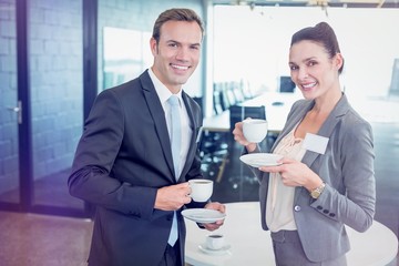 Fototapeta premium Businessman and businesswoman having tea during breaktime