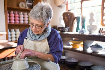 Female potter making pot