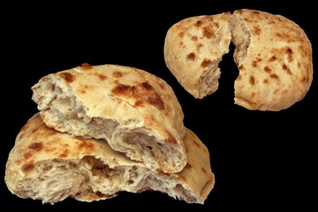 Two Pitta Bread Loafs Torn In Half Isolated On Black Background