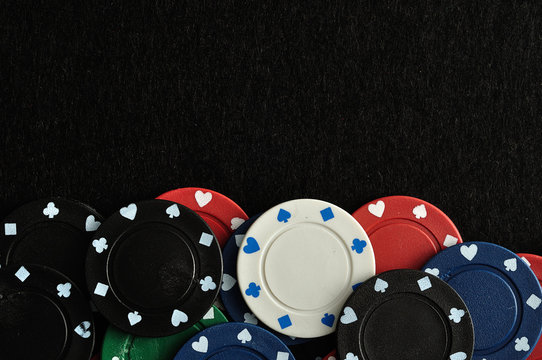 Poker chips forming a border with a black background