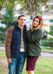 A young boy and girl hugging in the park