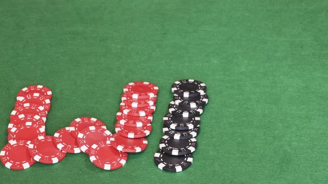 On empty green table word win out of casino chips, red w leeter, black i and blue n, gambling, poker game. Stop motion. Close up, 4K Ultra HD.