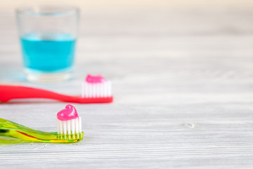 children's toothbrush oral care on wooden background