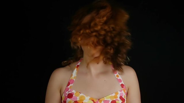 Red hair woman shakes her hairs