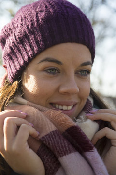 Young beautiful woman with a scarf and cap