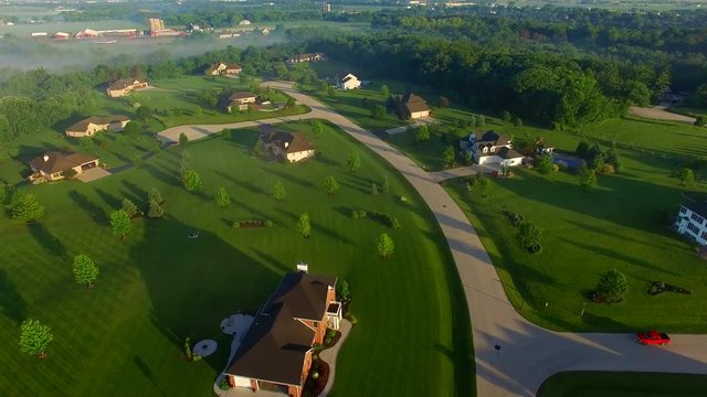 Beautiful neighborhoods, homes, suburbs, spectacular foggy sunrise, aerial view.
