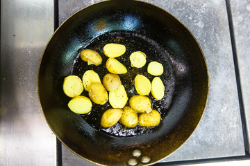 Bebbi-potatoes fried in a pan in the restaurant.