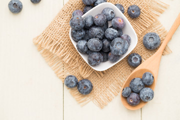blueberry on wooden spoons and cups,top view