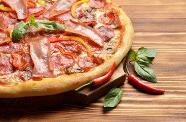 Big spicy tasty pizza with melting cheese bacon tomatoes ham pap