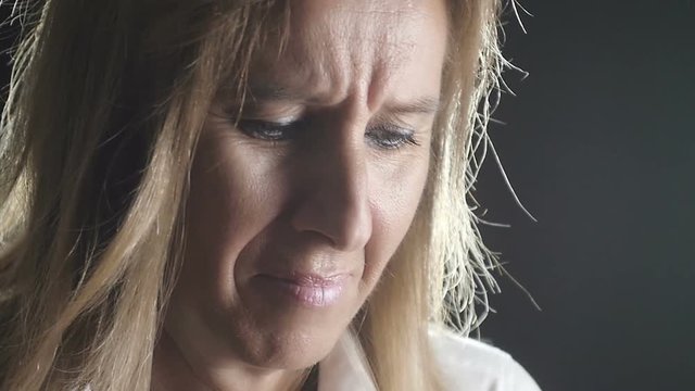 sad and depressed woman starts to cry- close up