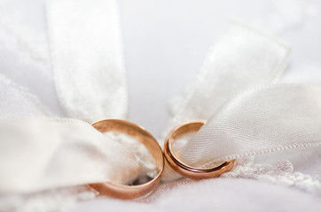 The composition of the wedding rings closeup lying on a cushion