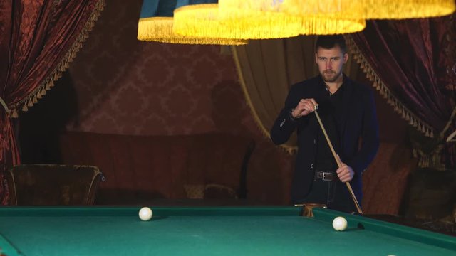 handsome serious man playing pool