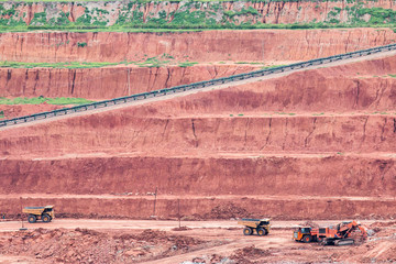 Obraz premium Part of a pit with big mining truck working