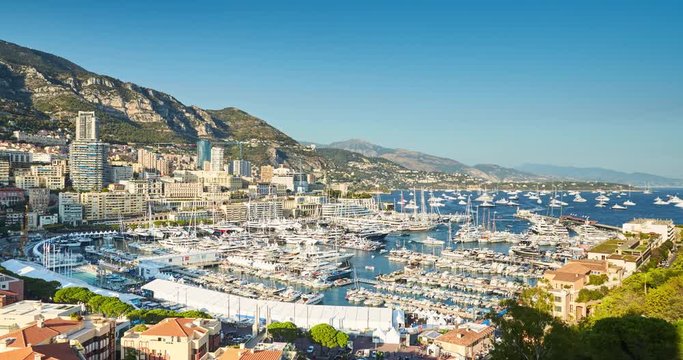 Monaco, Monte-Carlo, 27.09.2016: Timelapse of first day MYS Monaco Yacht Show, Port Hercules, luxury megayachts, big boat, view from Princes Palace of Monaco, sunset, aerial view, 4k video