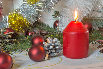 Christmas decoration with fir branches, cones and toys on white wooden background