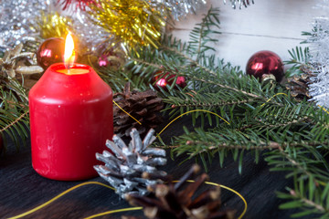 Christmas decoration with fir branches, cones and toys on white wooden background