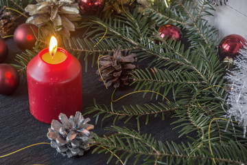 Christmas decoration with fir branches, cones and toys on white wooden background