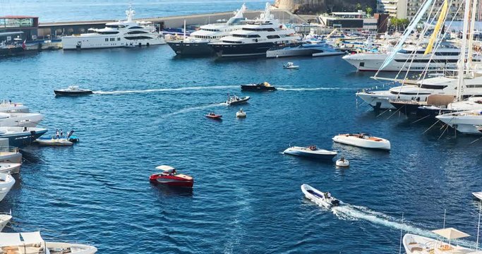 Monaco, Monte-Carlo, 29 September 2016: Timelapse of World Fair MYS Monaco Yacht Show, Port Hercules, luxury megayachts, many shuttles, taxi boat, presentations, Journalists, boat traffic, Azur water