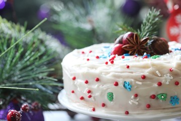 Homemade White Christmas cake with vanilla frosting and holiday sprinkles, selective focus