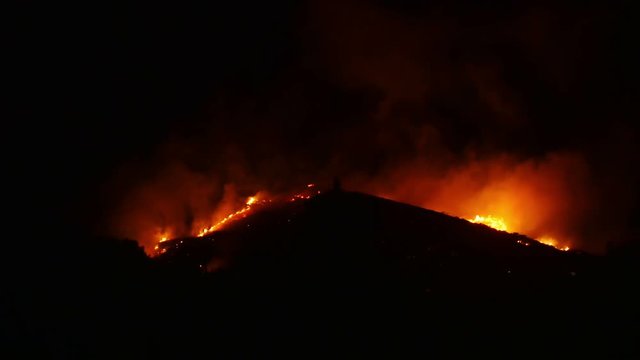 Huge bush fire at a mountain at night, 4k