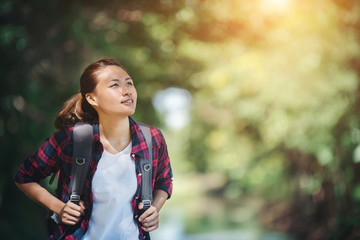 Hiking woman - hiker walking in the green forest.