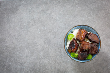 Chinese sweet and sour ribs. Dark gray stone background. Copy space. 