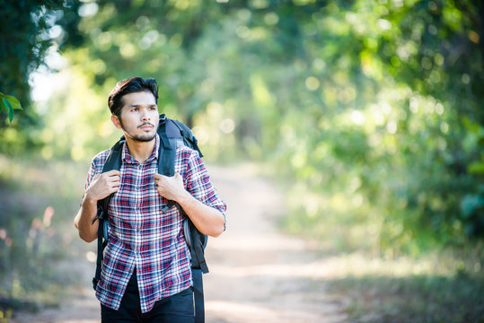 Young hipster man walking on the rural road during hikes on vaca