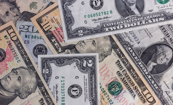 Closeup view Us Currency arranged randomly.