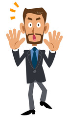 スーツを着用し髭を蓄えた褐色の男性が驚く
