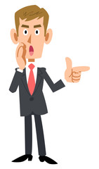 スーツを着用した茶髪のビジネスマンが指差しして囁く
