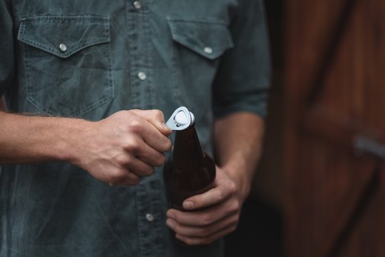 Man opening a beer bottle