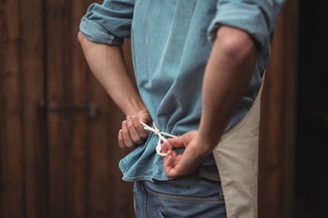 Man wearing apron at home brewery