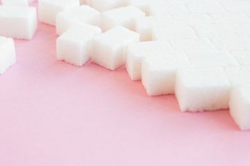 Sugar cubes steps on a pink background