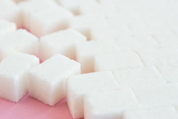 Sugar cubes steps on a pink background
