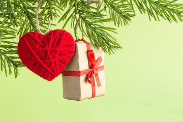 Christmas toy heart and gift box hanging on the Christmas tree.