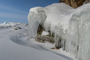 Beautiful icicles on rocks. Winter landscape in Lake Baikal.