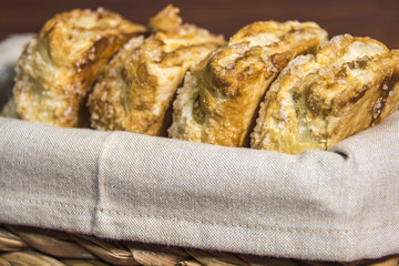 Basket of freshly layered, apple braided danish