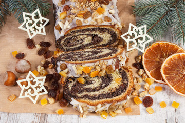 Homemade poppy seeds cake and spruce branches, dessert for Christmas