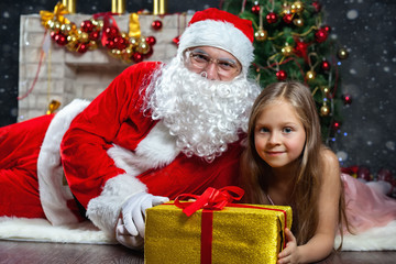 Fototapeta na wymiar Santa Claus and a girl in a dress. Christmas Scenes.